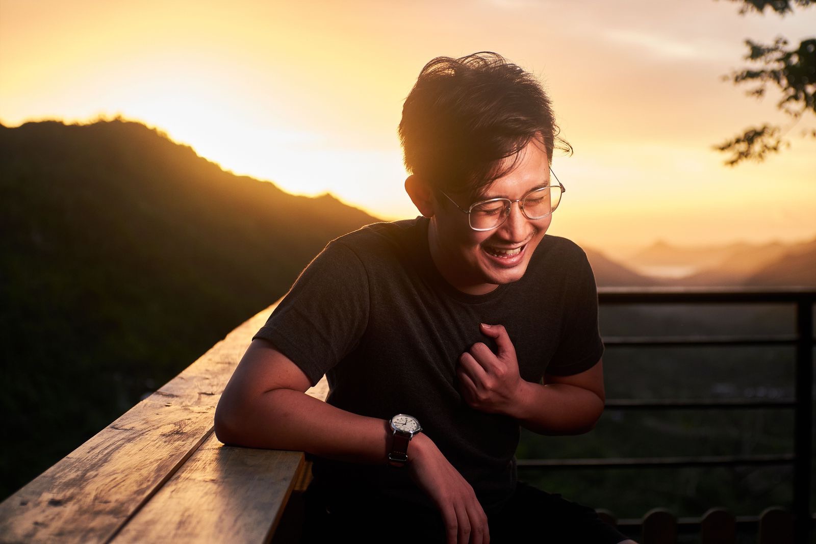 A confident man laughing at sunset